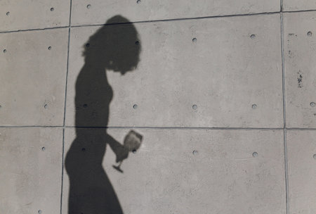 shadow of a woman on a gray wall.の写真素材