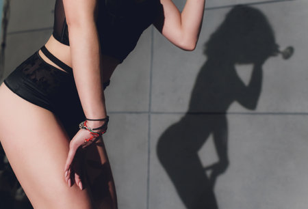 maid. Hot girl. Luxury ass. Stockings. Slender legs. Game costume. Athletic body. Girl in black lingerie and stockings. Temptation. Silicone implants. Buttocks.の写真素材