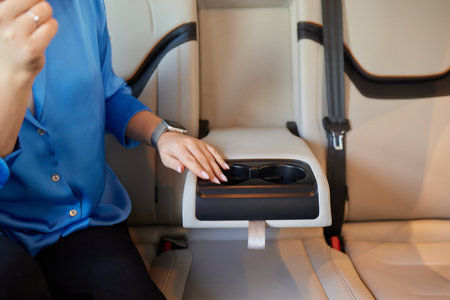female hand opens the Cup holder in the carの写真素材
