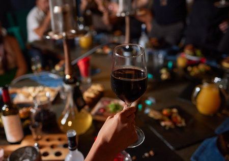 At a lively nightclub, people are enjoying wine and socializing in a chic ambiance