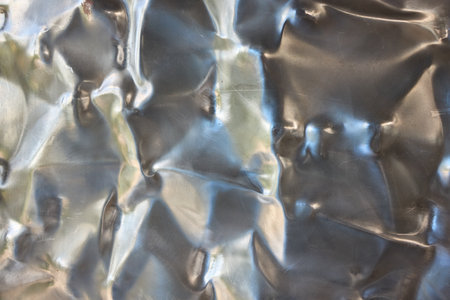 Crinkled Metallic Texture Background merges art with design, creating a futuristic surfaceの写真素材