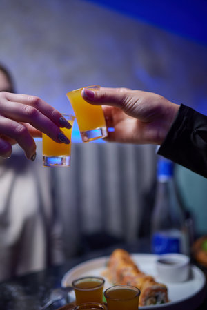 At a lively nightclub, people are enjoying wine and socializing in a chic ambiance