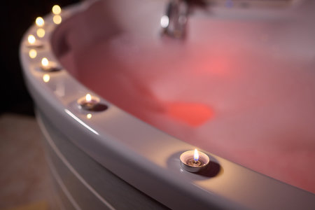 Enjoy a relaxing bubble bath in a luxurious setting with soft, soothing candlelightの写真素材