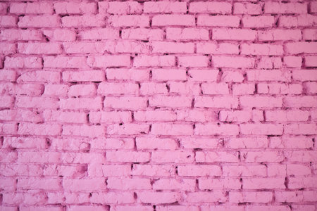 A vibrant pink brick wall texture background that is visually striking and bold in colorの写真素材