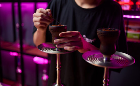 Person holding a hookah at a drinking establishment event