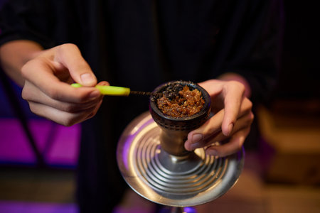 Person holding a hookah at a drinking establishment eventの写真素材