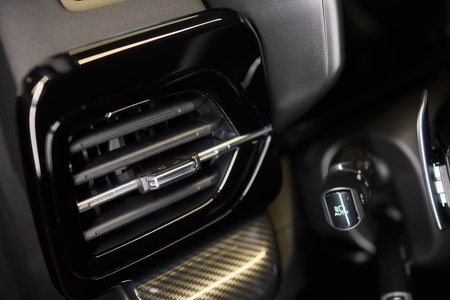 Closeup of car dashboard air vents near gear shift