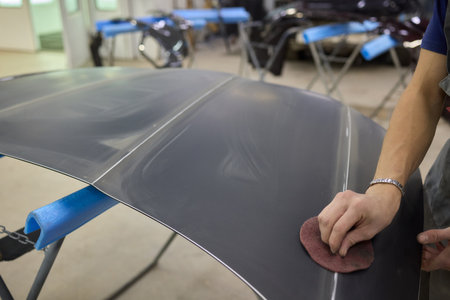 The Auto Body Repair Process involves key steps like sanding and refinishing vehicle partsの写真素材