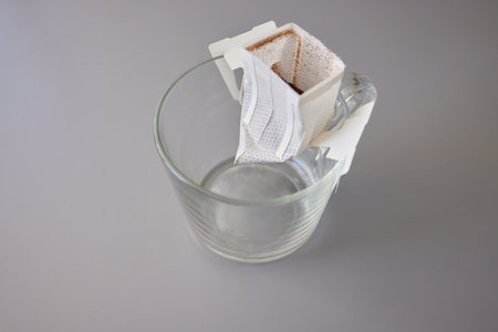 brewing process,a bag filled with boiling water for drip coffee in a cup,top view.の写真素材