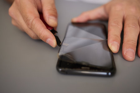 replacing broken glass with a new one. Broken smartphone display. Broken glass phone. Smartphone repairの写真素材
