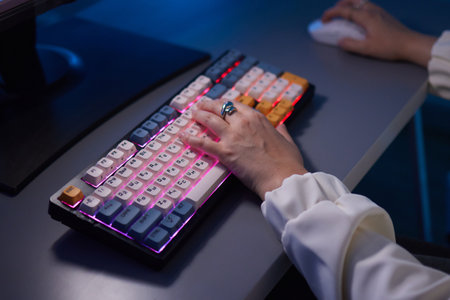 a person is typing on a keyboard with a ring on their finger