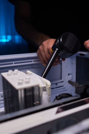 Cleaning old dusty electronics computer, lots of dirt and dust blown by compressed air, old wires and steel, old wires cleaning by professional specialistの写真素材