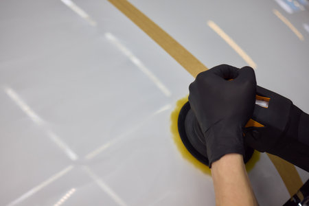 Person using machine to polish cars automotive exteriorの写真素材