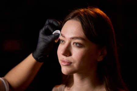 An Exciting Vibrant Blue Eyebrow Styling Session Filled with Fun and Creative Aestheticsの写真素材