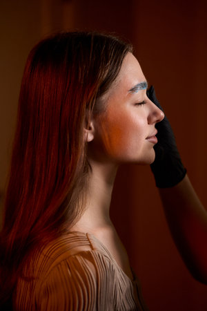 An Exciting Vibrant Blue Eyebrow Styling Session Filled with Fun and Creative Aestheticsの写真素材