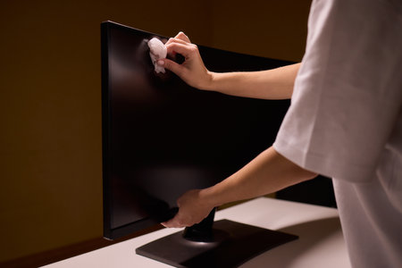 Cleaning a Modern Television Screen Effectively for Optimal Clarity and Brightnessの写真素材