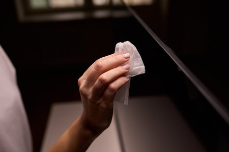 Cleaning a Modern Television Screen Effectively for Optimal Clarity and Brightnessの写真素材
