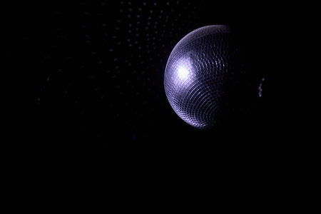 A Disco Ball Shining Red Light, Creating an Energetic Atmosphere Perfect for Celebratingの写真素材