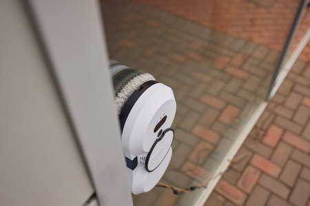 A robotic white Automotive tire is cleaning a glass windowの写真素材