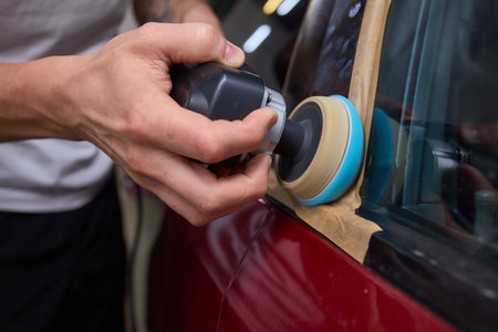 Car detailing enhances shine of vehicle with machine buffer for glossy finish