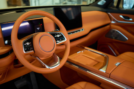 Closeup of a modern car steering wheel with control buttons for technology and convenience
