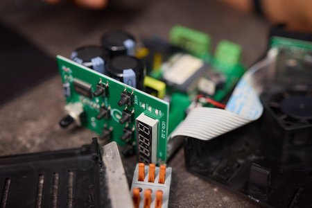 burnt Electronic circuit board with cooling fan and ribbon cable for hardware technology