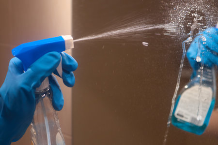 Professional cleaners prioritize hygiene using blue gloves and cloths for thorough cleaning
