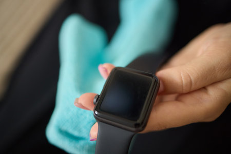 Ensure optimal performance and longevity of your smartwatch by cleaning it with a microfiber clothの写真素材