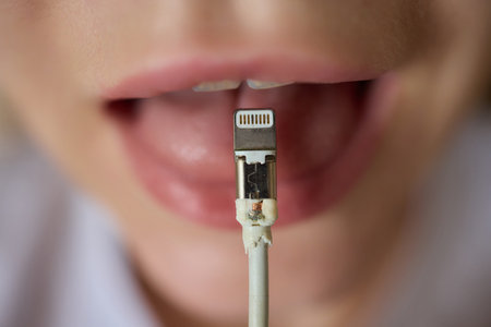 An aesthetic image showing a womans lips biting a USB cable in a modern tech setting