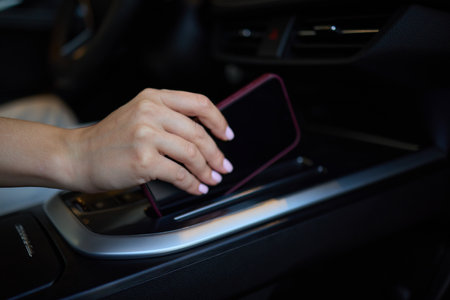 Placing Smartphone on Car Center Console for Enhanced Convenience and Connectivityの写真素材