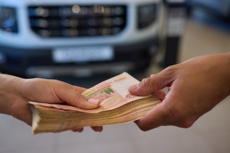 Car Purchase Transaction involves the exchange of money for the car and handing over of car keysの写真素材