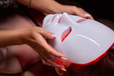 LED Facial Mask Therapy uses Light Therapy Mask for skincare rejuvenation and wellnessの写真素材