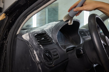 Car Interior Cleaning process underway with a brush for detailed professional detailingの写真素材