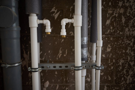 Overview of Industrial Pipes and Insulation prominently featured in a Basement Settingの写真素材