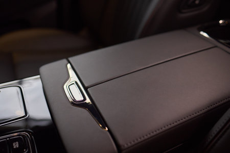 The car features a highend interior, but shows wear and tear with a armrest