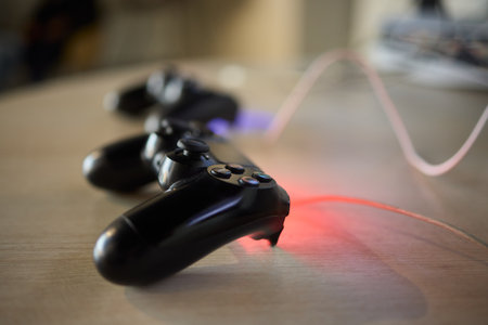 Black Gaming Controllers are placed on a Wooden Table, showcasing their modern design and style