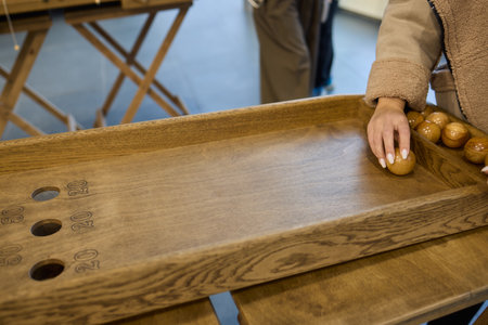 Enjoy a Classic Shuffleboard Game with a beautifully crafted Wooden Board and Puck for funの写真素材