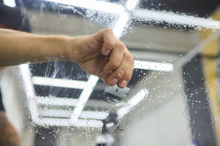 Installing windshield on a car with automotive designの写真素材
