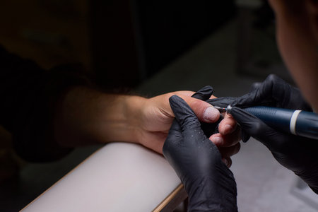 Get an exquisite professional nail art procedure in a modern salon setting filled with eleganceの写真素材