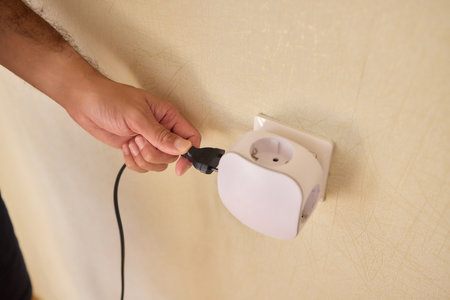 Hand Plugging in an Electrical Device for Essential Power Supply and Utility Connection