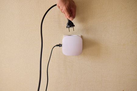 Hand Plugging in an Electrical Device for Essential Power Supply and Utility Connection