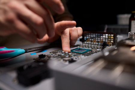 Hand Repairing a Graphics Card through the Application of Thermal Paste for Better Performanceの写真素材