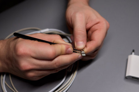 Repairing Earbuds Close Up of Effective Cable Maintenance Techniques and Tips for Successの写真素材