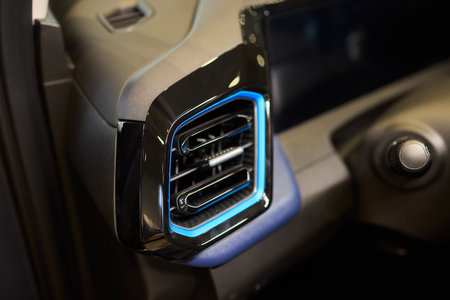 Closeup of car dashboard air vents near gear shift