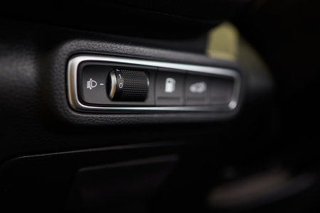A closeup of the cars interior light control dial, highlighting its intricate design