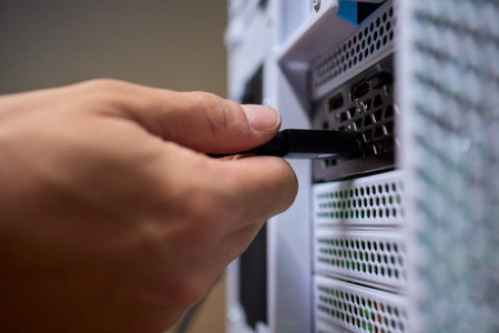 Connecting a Cable to a Computer Server for Proper Functionality and Communication Needsの写真素材
