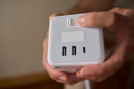 A closeup view of a hand skillfully adjusting a button on a modern, advanced deviceの写真素材