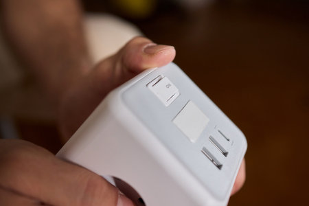 A closeup view of a hand skillfully adjusting a button on a modern, advanced device