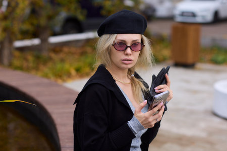 Trendy Young Woman Engaged with Her Smartphone While Surrounded by Beautiful Nature