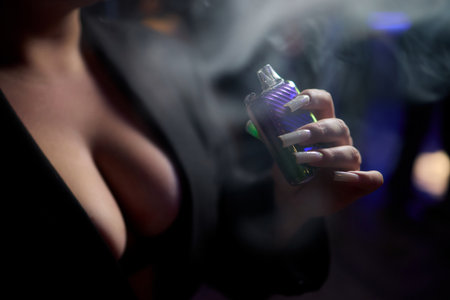 Exploring Vaping Culture A Vape Device in Action Surrounded by Colorful Vapor Clouds